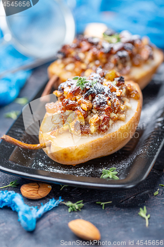 Image of Delicious baked pears with nuts and raisins.