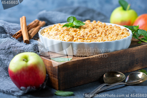 Image of  Apple crumble in white ceramic baking form.