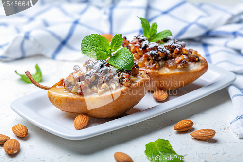 Image of Pears baked with raisins, nuts, honey and mint.