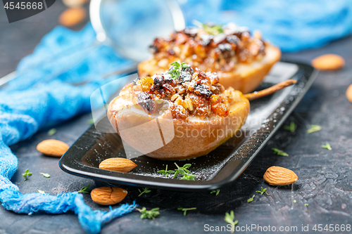 Image of Baked pear with raisins, nuts and honey.