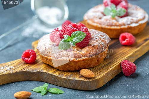 Image of Delicious mini-tarts (tartlets) with raspberries.