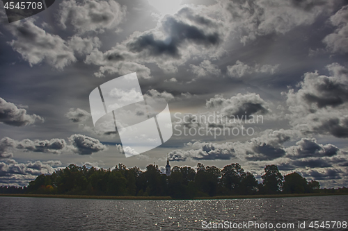 Image of Church on island with clouds and sun