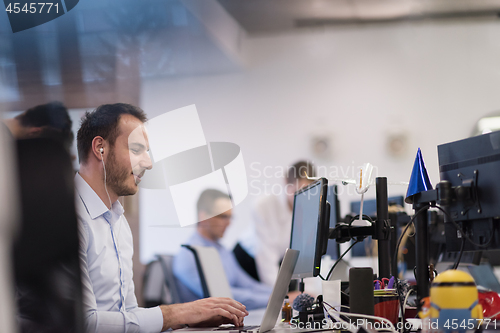 Image of businessman working using a laptop in startup office