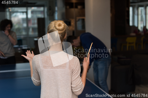 Image of startup business team playing ping pong tennis