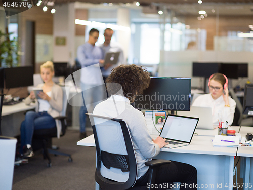 Image of businessman working using a laptop in startup office