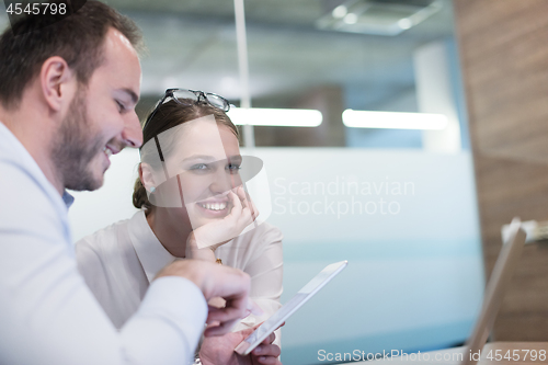 Image of Business People Working With Tablet in startup office