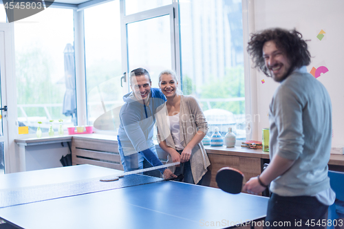 Image of startup business team playing ping pong tennis