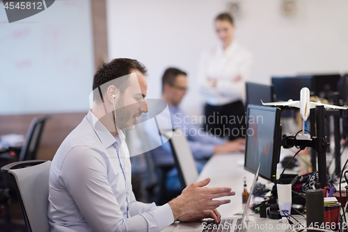 Image of businessman working using a laptop in startup office