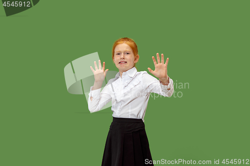 Image of Portrait of the scared teen girl on green