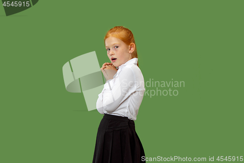 Image of Portrait of the scared teen girl on green