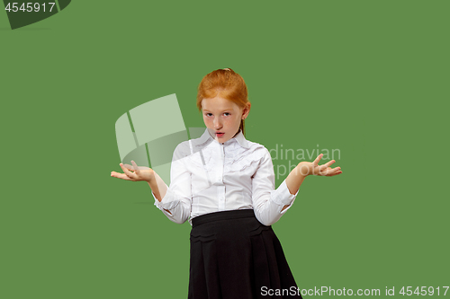 Image of Beautiful teen girl looking suprised and bewildered isolated on green