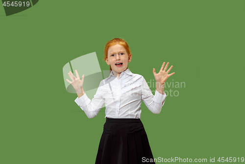 Image of Portrait of the scared teen girl on green