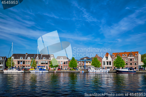 Image of Boats and houses on Spaarne river. Haarlem, Netherlands