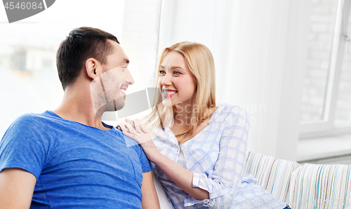 Image of happy couple with laptop computer at home