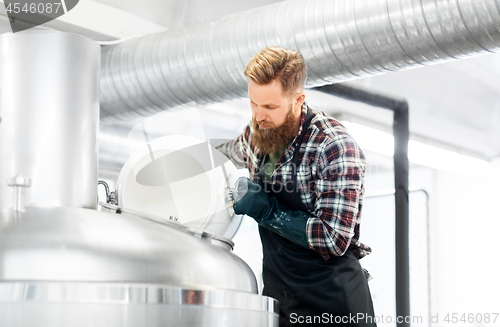 Image of man working at craft brewery or beer plant