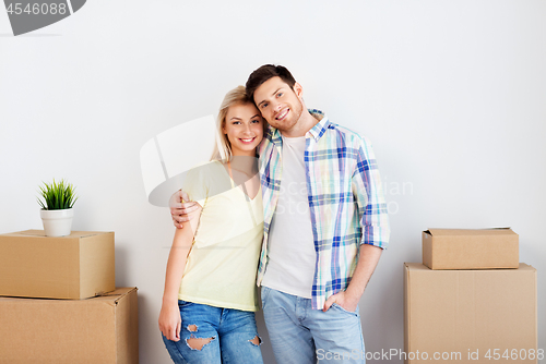 Image of happy couple with boxes moving to new home