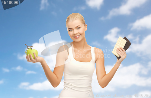 Image of woman choosing between green apple chocolate