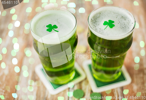 Image of glasses of green beer with shamrock and gold coins