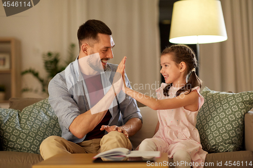 Image of father and daughter doing homework together