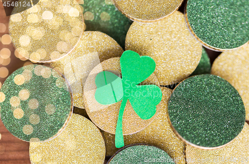 Image of close up of golden coins and green shamrock leaf