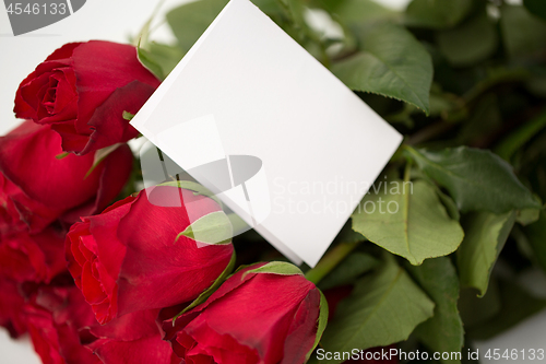 Image of close up of red roses and letter or note