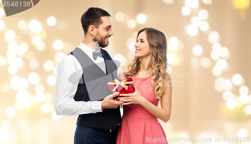 Image of happy couple with gift on valentines day