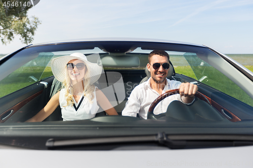 Image of happy man and woman driving in cabriolet car