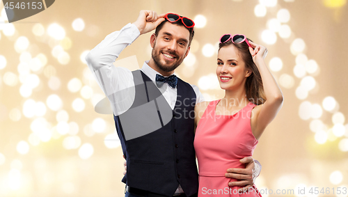 Image of happy couple in heart-shaped sunglasses