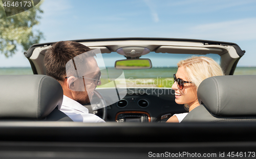 Image of happy man and woman driving in cabriolet car