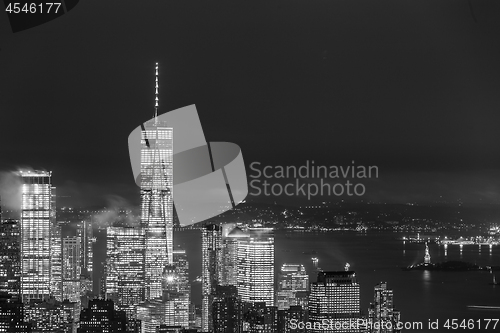 Image of New York City skyline with lower Manhattan skyscrapers in storm at night.