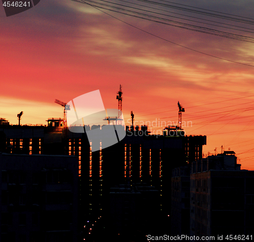 Image of Cranes and Construction Equipment on Sunrise