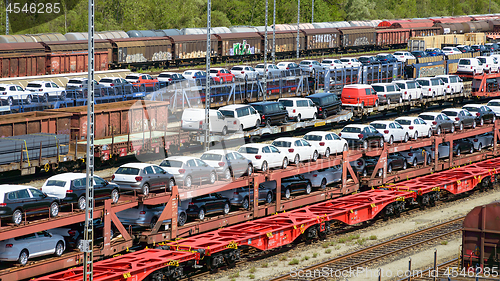 Image of lots of new cars loaded on railway autorack wagons ready for shi