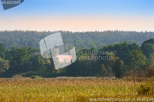 Image of Upper Bavarian autumn landscape with small church in morning mis