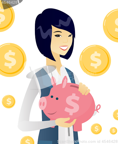 Image of Young asian business woman holding a piggy bank.