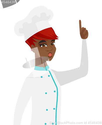 Image of African chef with open mouth pointing finger up.