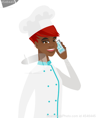 Image of African-american chef talking on a mobile phone.