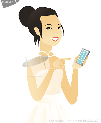 Image of Young asian fiancee holding a mobile phone.