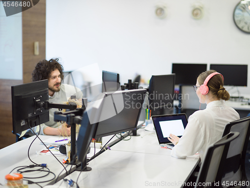 Image of businesswoman using a laptop in startup office