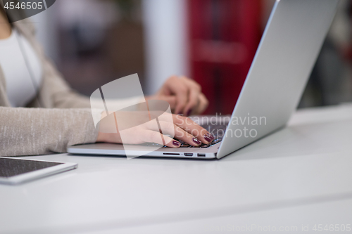 Image of businesswoman using a laptop in startup office
