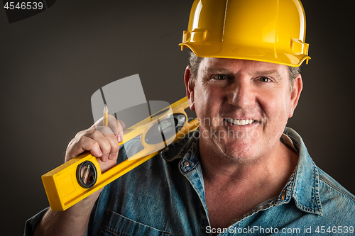 Image of Smiling Contractor in Hard Hat Holding Level and Pencil With Dra