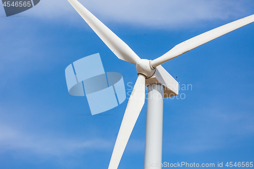 Image of Single Wind Turbine Over Dramatic Blue Sky