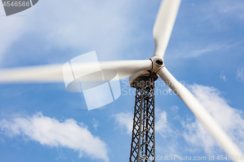 Image of Single Wind Turbine Over Dramatic Blue Sky