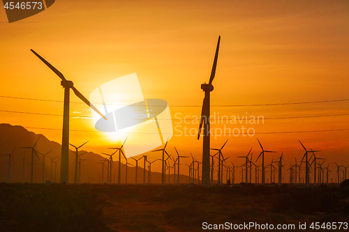 Image of Silhouetted Wind Turbines Over Dramatic Sunset Sky