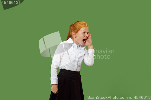 Image of Isolated on green young casual teen girl shouting at studio
