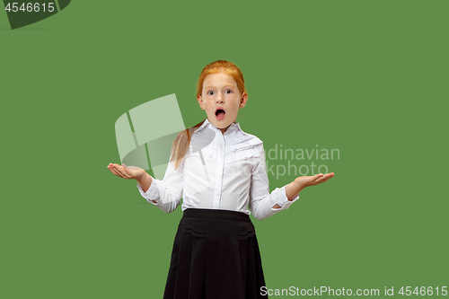 Image of Beautiful teen girl looking suprised isolated on green