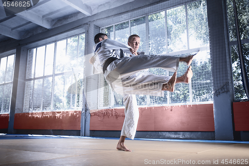 Image of Two judo fighters showing technical skill while practicing martial arts in a fight club