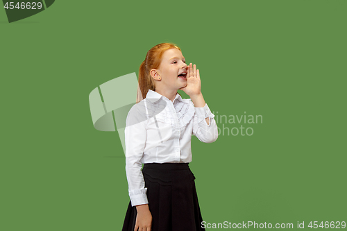 Image of Isolated on green young casual teen girl shouting at studio