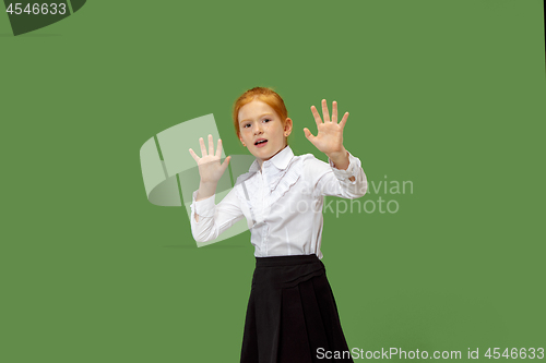 Image of Portrait of the scared teen girl on green