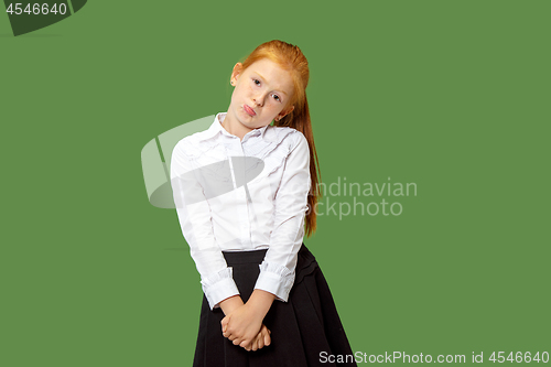 Image of Beautiful teen girl looking suprised and bewildered isolated on green