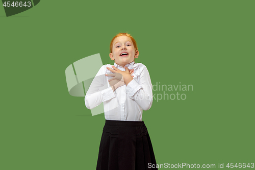 Image of Beautiful teen girl looking suprised isolated on green